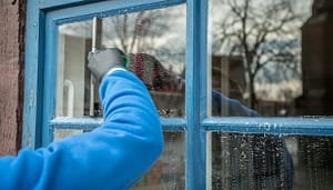 man cleaning window